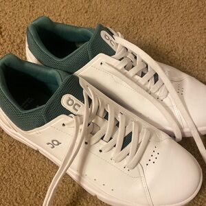 White on cloud sneaker with green back.